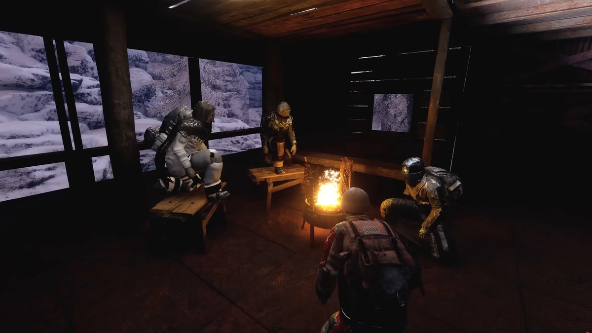 Permafrost – four survivors gathered around campfire inside base